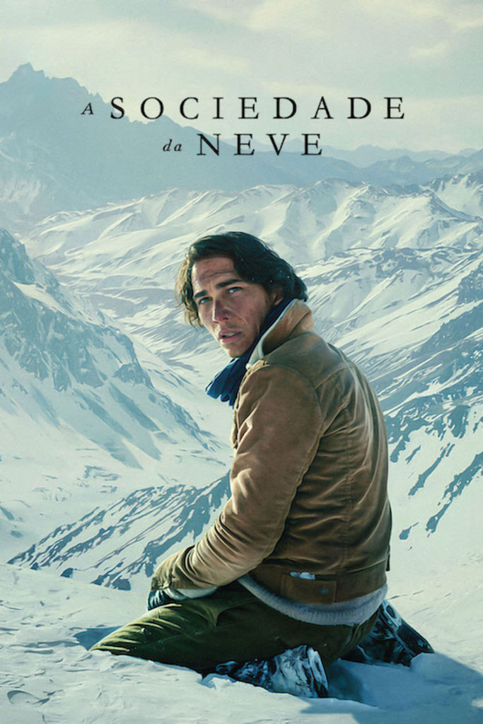 Homem sentado na neve com montanhas ao fundo, simbolizando resiliência e a pulsão de vida.